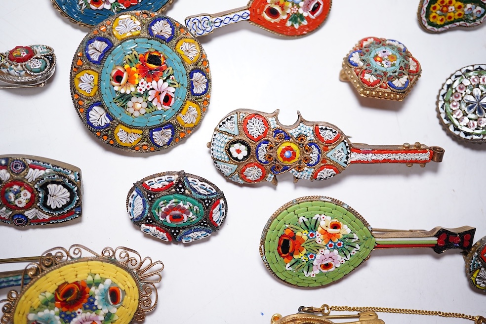 A collection of twenty-five micro-mosaic costume jewellery brooches. Including thirteen banjo and guitars shaped brooches, six large oval and circular brooches and six smaller brooches. Condition - mostly good